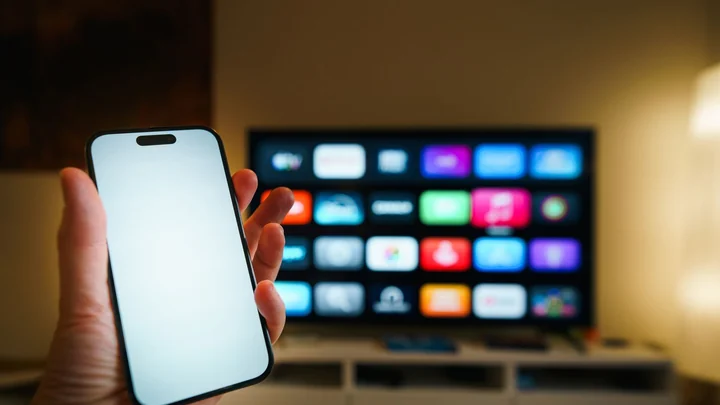 Smartphone held in front of a smart TV for hotspot WiFi setup