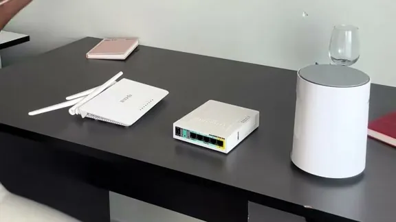 Hotspot starter equipment on a desk - Tenda F3 router, MikroTik hAP lite and a 4G CPE
